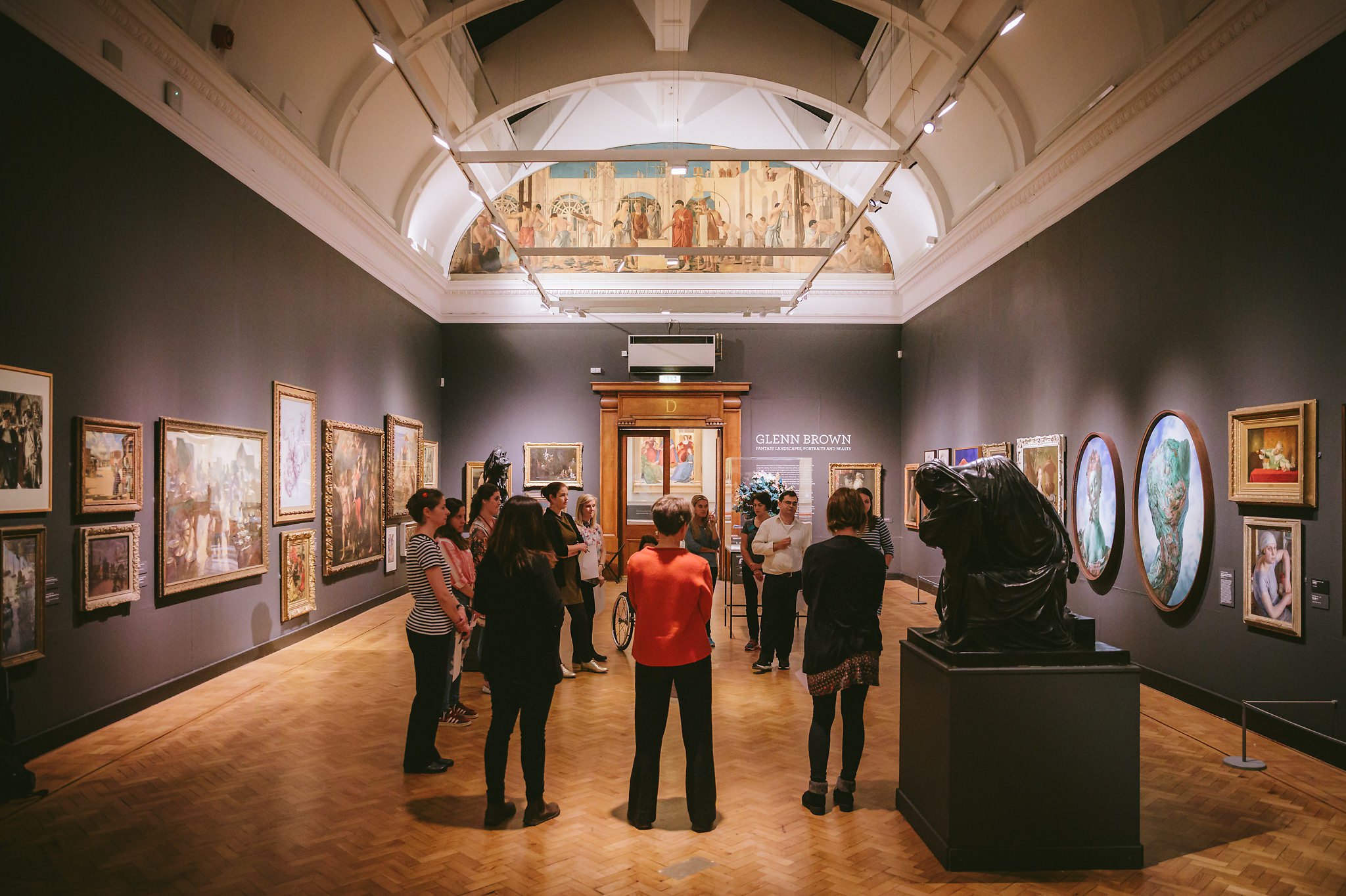 A circle of people in discussion at an art gallery.