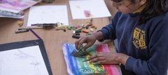 child making pastel drawing