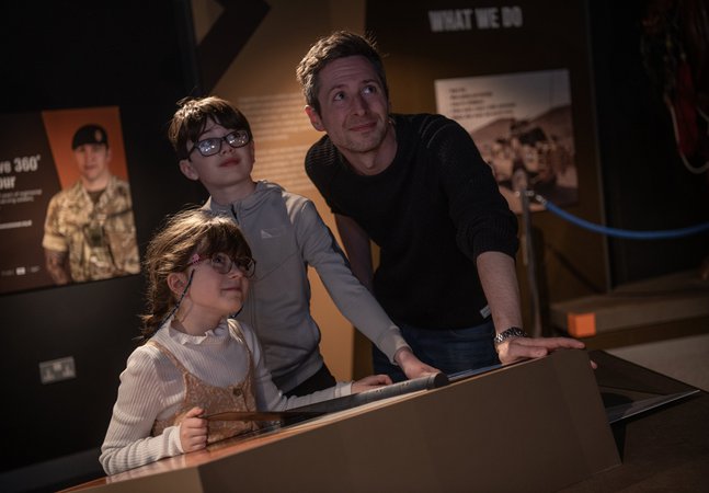 a family group, dad and son and daughter looking up