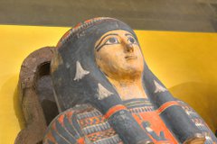 Ancient Egyptian decorated coffin with golden female face and headdress
