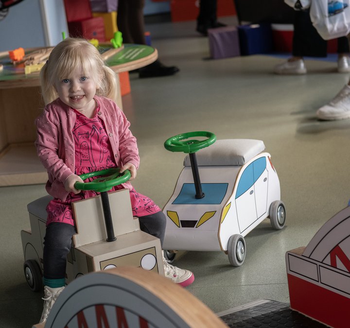 little girl on toy car in Tint Tyneside
