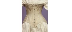 a pale pink Victorian corset on a mannequin