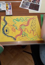 Two young people creating art using pastels