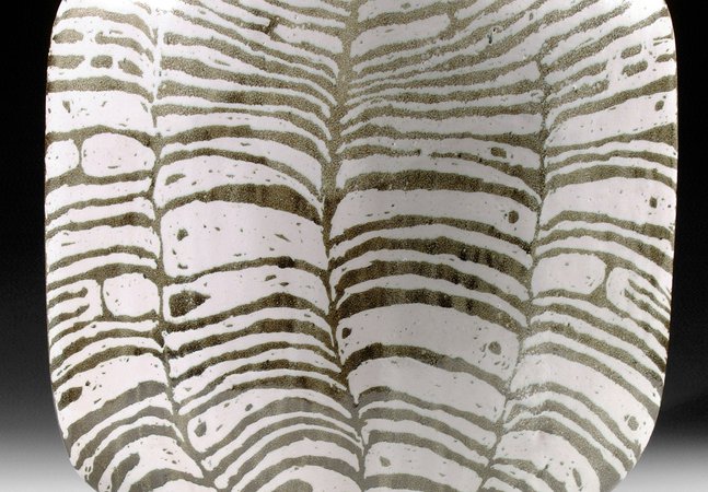 A black and white striped ceramic vessel
