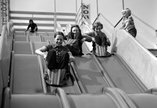 Archive photograph of people on slides at a funfair