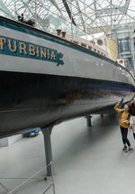family in Discovery Museum look around