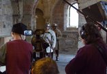 A film crew shooting in a castle.