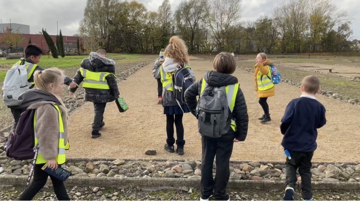 Group of school children exploring Roman fort site