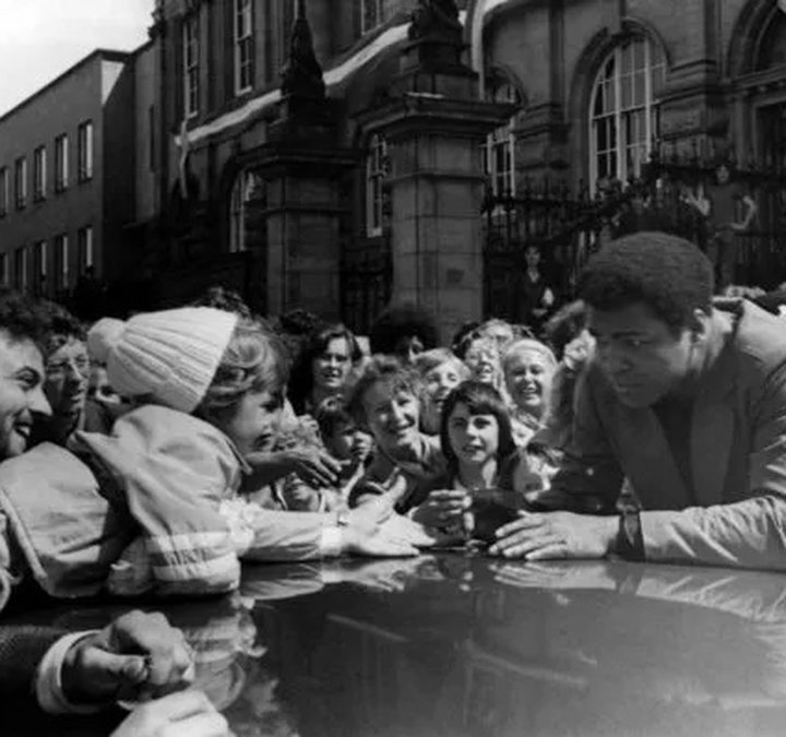 Muhammad Ali greets a young fan outside South Shields Town Hall on Saturday 16 July 1977. Photo by Fred Muddit of Fietscher Fotos, courtesy of South Tyneside Libraries. STH0005016.