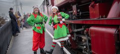 Elves dressed in a green elf costume at the Elf Express