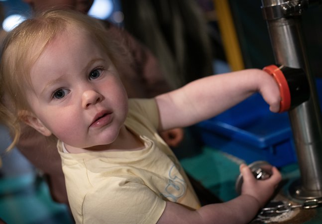 little girl plays in gallery