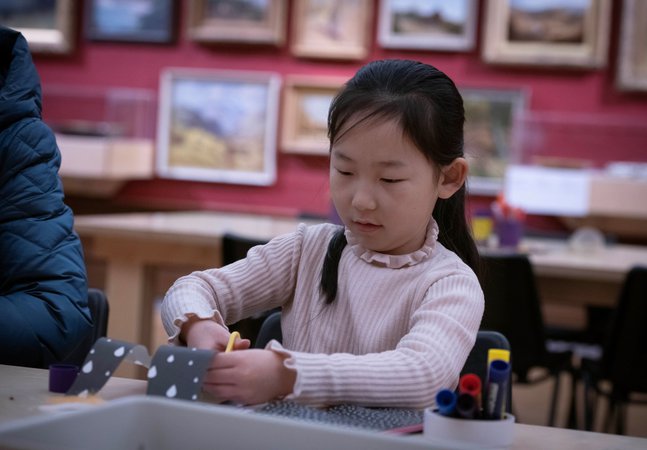 A photograph of a young girl crafting.