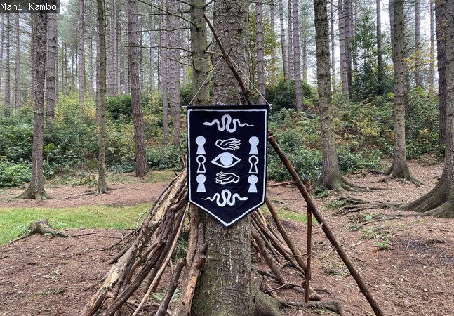 A banner with symbols hangs from a tree