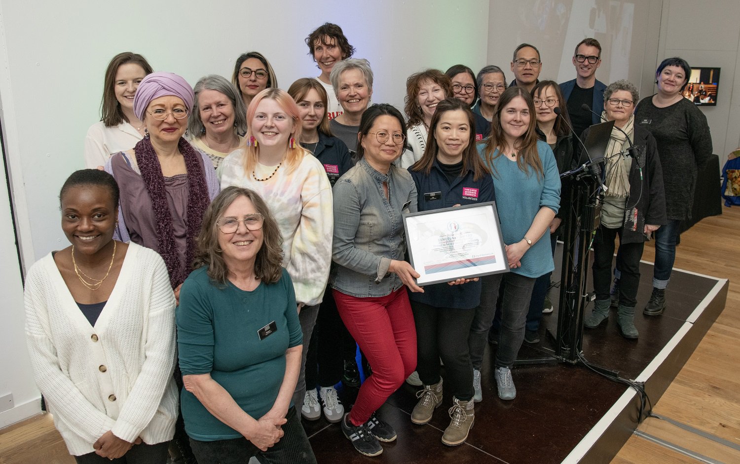 Staff and volunteers accepting a Museums of Sanctuary award.