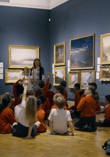 school children sitting down in the gallery 
