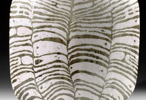 A black and white striped ceramic vessel
