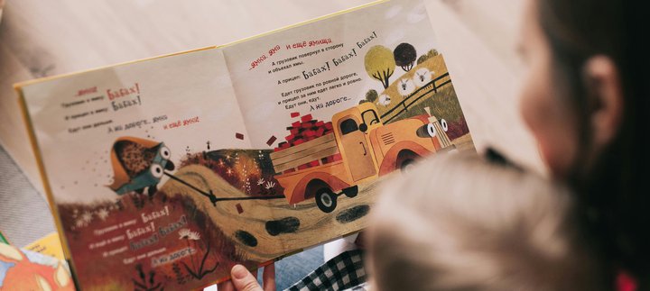 Mother reading a book to a small child