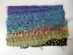 A photograph of an embroidered summer landscape.