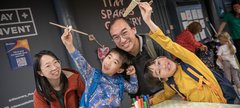Family group with parents and two children smile at camera  