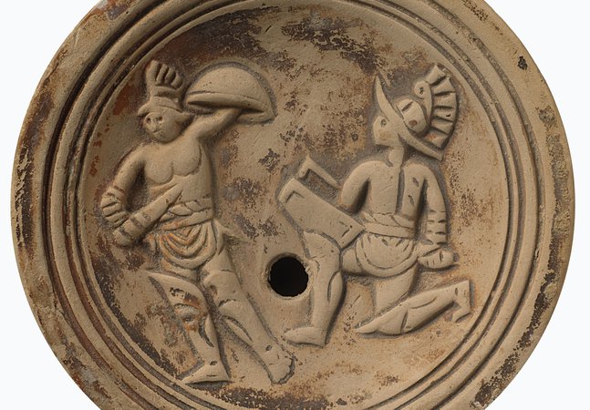 Roman terracotta lamp showing outline of two gladiators in combat 