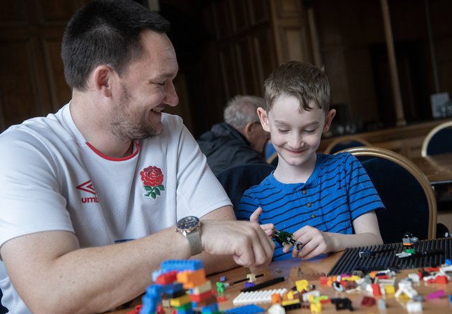 A dad and son playing with construction toys