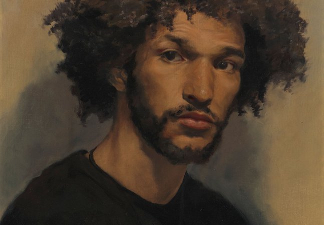 A portrait of a young man against a brown backdrop.