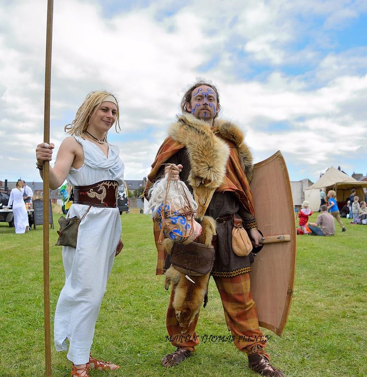 Woman and man dressed as Celts with woad designs on their faces
