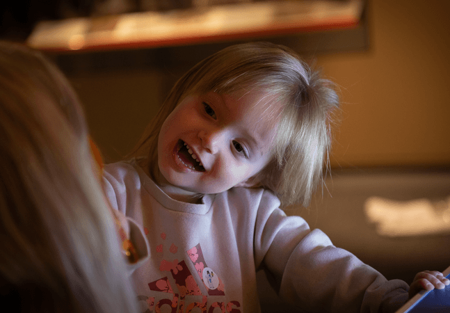 smiling young girl tilts head 