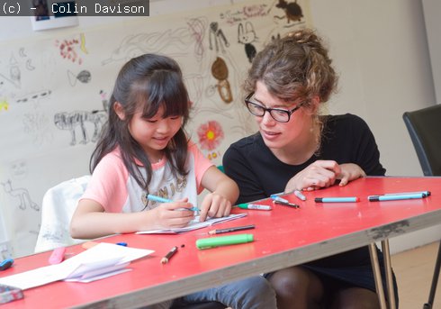 Young girl talking to an art educator