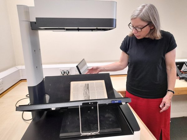 Archives staff member at copying machine Archives staff member at copying machine