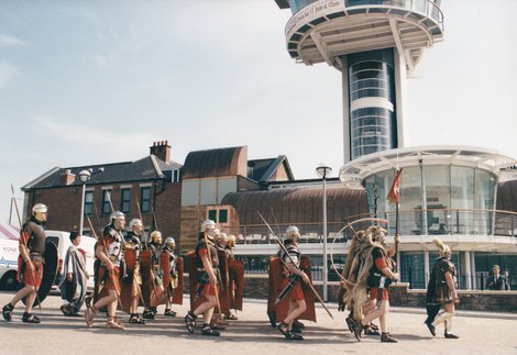 Roman soldiers parading past Segedunum Roman Fort tower