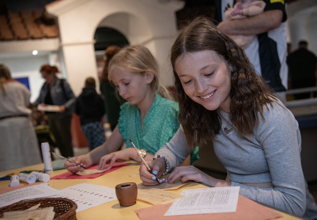 Two girls in Roman Gallery taking part in a writing activity expirers 