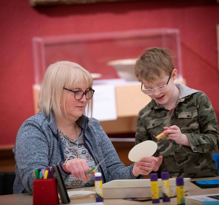 A photograph of a mum and child doing crafts together.