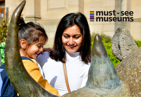 Mother and daughter outside a museum.