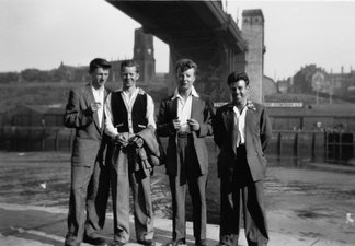 Four men at stand on the River  Tyne quayside