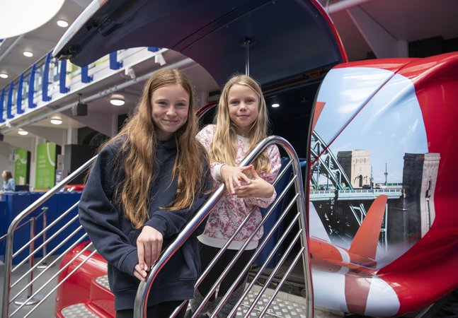 Two girls at RAF simulator ride 