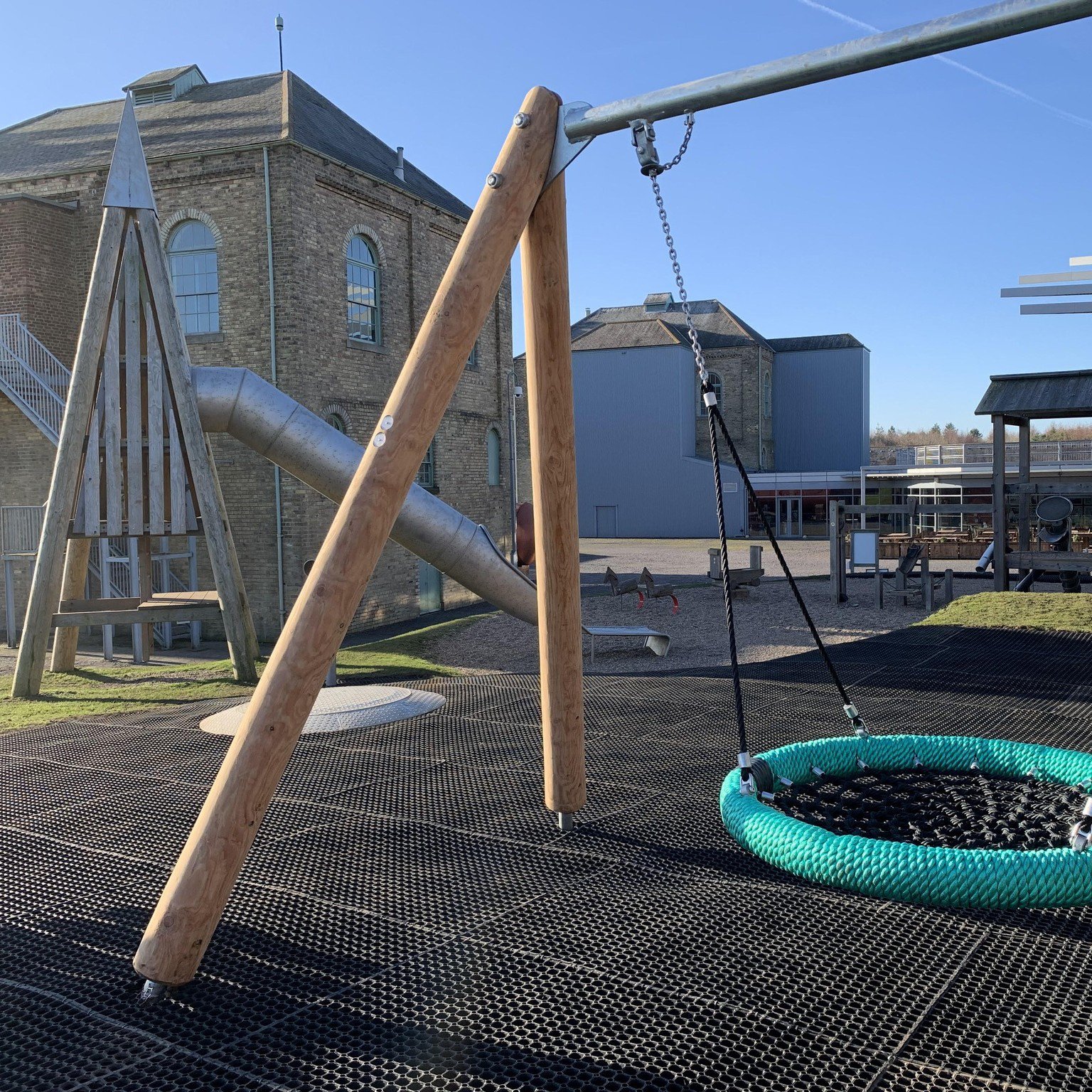 Adventure playground with slide and swing.