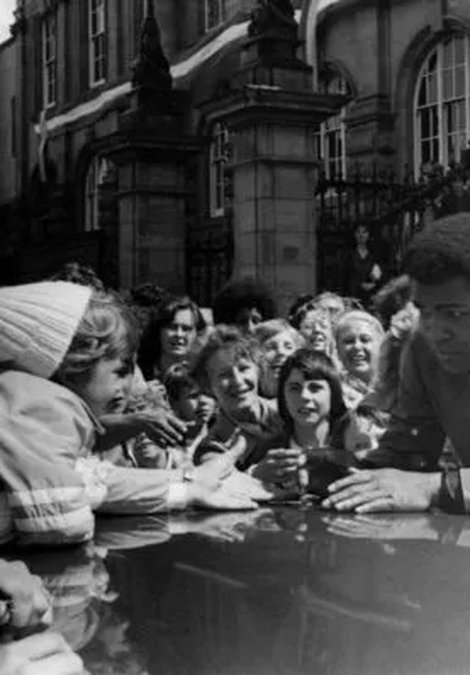 Muhammad Ali greets a young fan outside South Shields Town Hall on Saturday 16 July 1977. Photo by Fred Muddit of Fietscher Fotos, courtesy of South Tyneside Libraries. STH0005016.