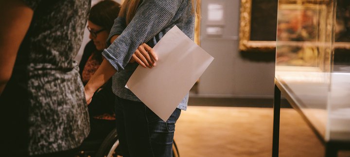 Photo of a woman holding a bit of paper