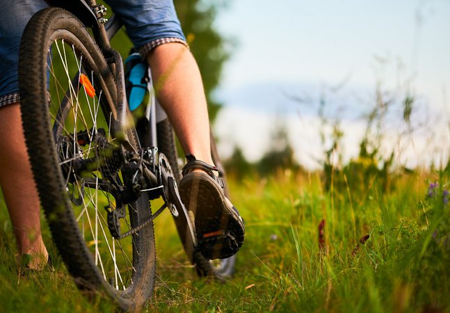 Lower half view of a person riding a bicycle