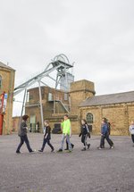 School children walking in a line in the outside of Woodhorn 