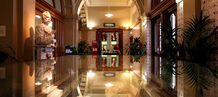 Photograph of the Laing's marble hall with a statue of founder Alexander Laing and the cafe in the background