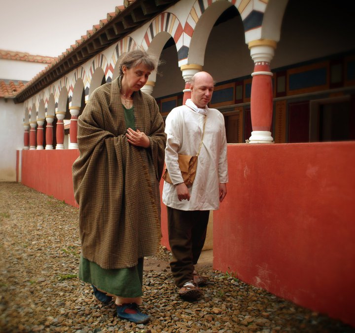 Man and Woman in Roman civilian dress walking through the Commanding Officer's courtyard