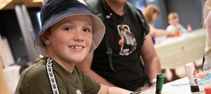 boy smiling doing crafts