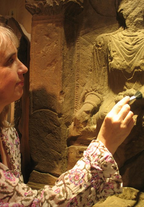 Keeper of Archaeology Alex Croom cleaning the Regina Tombstone