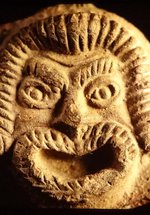 Pottery lamp detail showing a theatrical mask