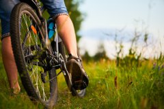 Lower half view of a person riding a bicycle