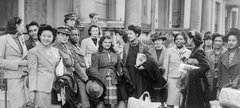 A group of West Indian women recruited to join the ATS, wait for transport to take them to their train© IWM AP 14372D