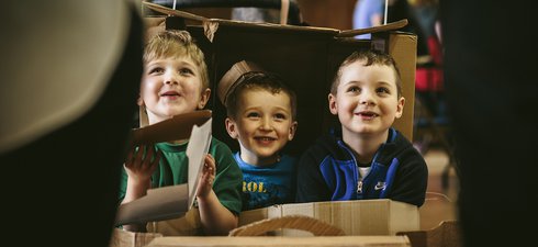 Children playing with cardboard