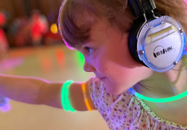 Young girl with headphones dances 